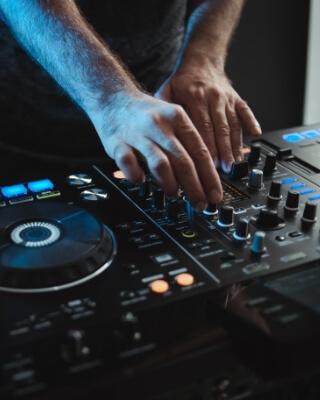 Close-up of a DJ mixing live on the controller