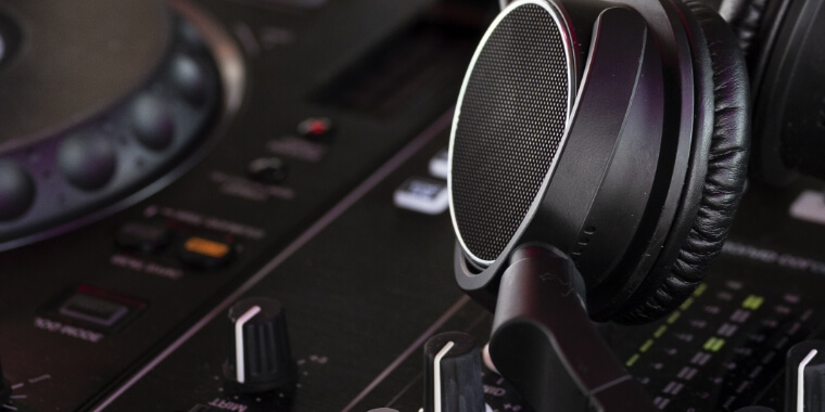 DJ headphones resting on a mixing controller