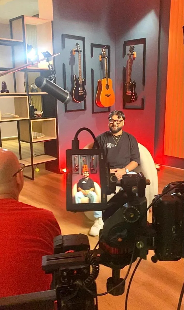 Interview filming in the BarCoe Studios lounge with camera and microphone